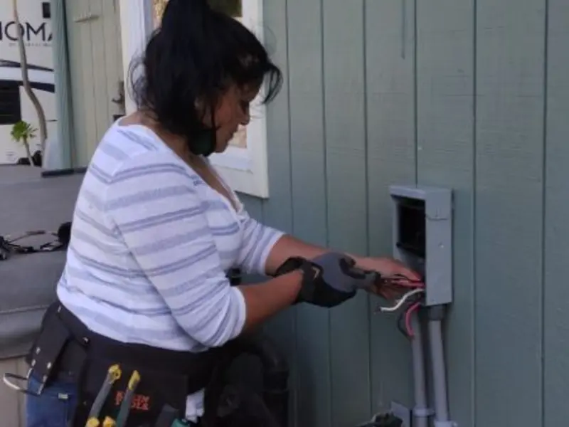 Licensed electrician wiring an exterior subpanel in Reserve